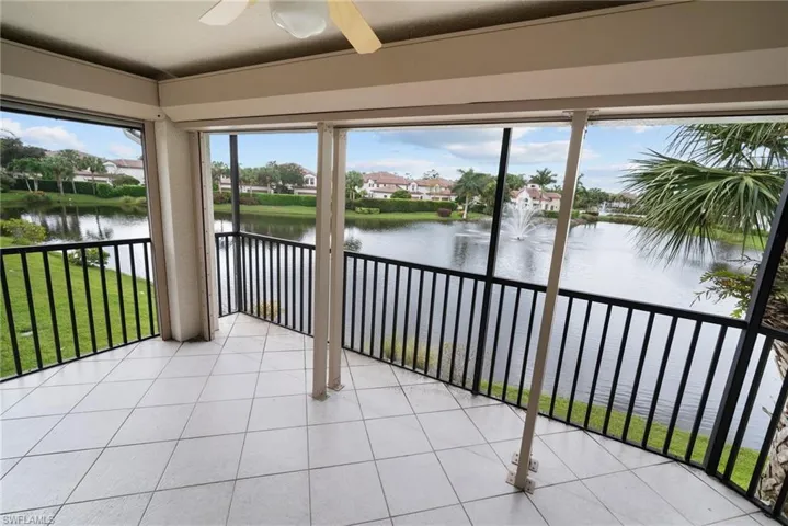 Unfurnished sunroom featuring a water view and ceiling fan