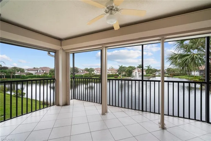 Unfurnished sunroom featuring a water view and ceiling fan