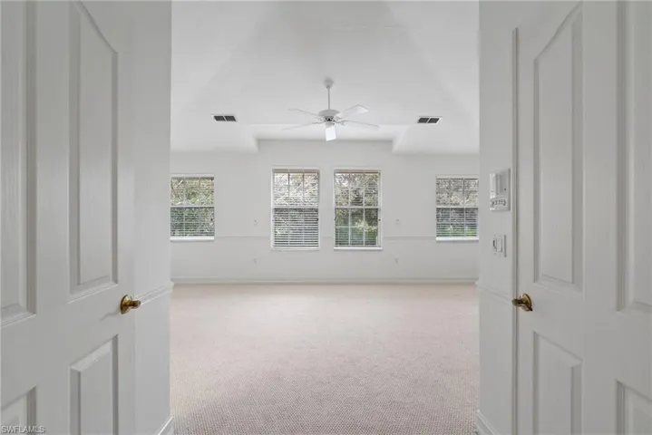 Unfurnished room with light carpet and ceiling fan