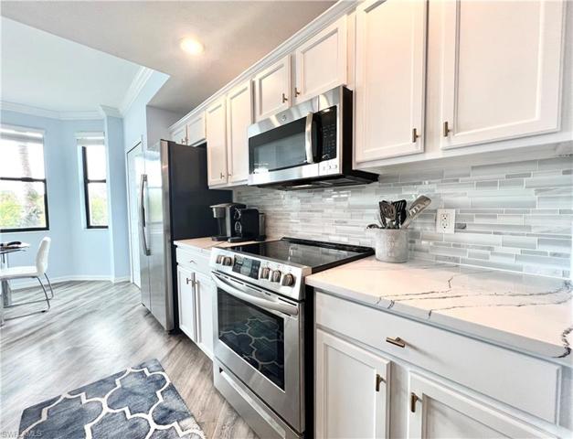 Kitchen with new quartz countertops and glass backsplash
