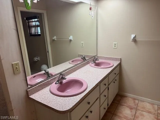 Bathroom featuring tile patterned flooring, vanity, and toilet