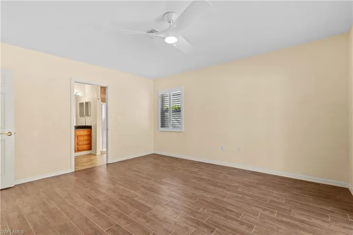 Spare room featuring ceiling fan and light wood-type flooring