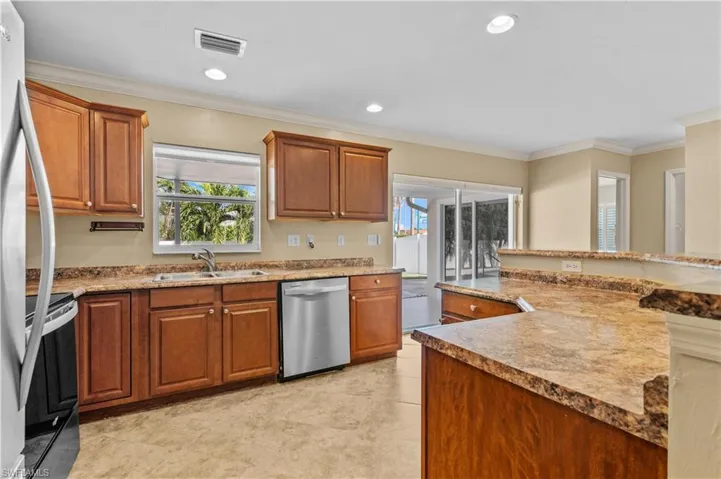 Kitchen featuring crown molding, stainless steel appliances, and sink