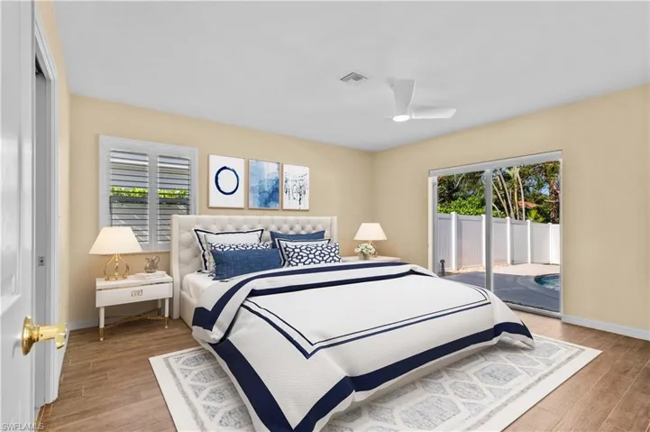 Bedroom with access to exterior, light hardwood / wood-style flooring, multiple windows, and ceiling fan
