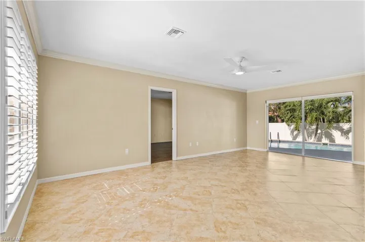 Spare room featuring ceiling fan and ornamental molding