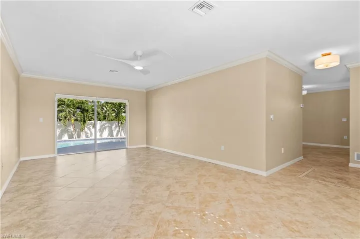 Unfurnished room with ornamental molding and ceiling fan