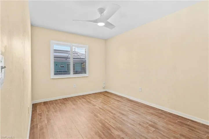 Empty room featuring light wood-type flooring and ceiling fan