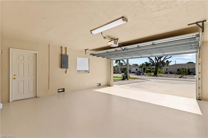 Garage with a garage door opener and electric panel