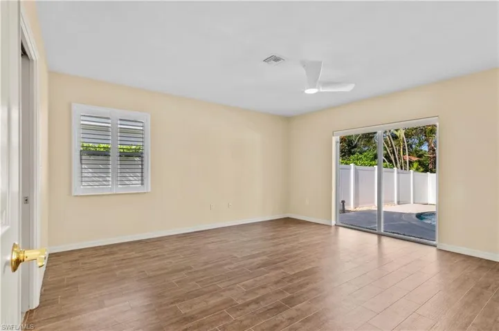 Empty room featuring ceiling fan and hardwood / wood-style flooring