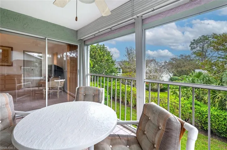 Sunroom / solarium with a balcony and ceiling fan