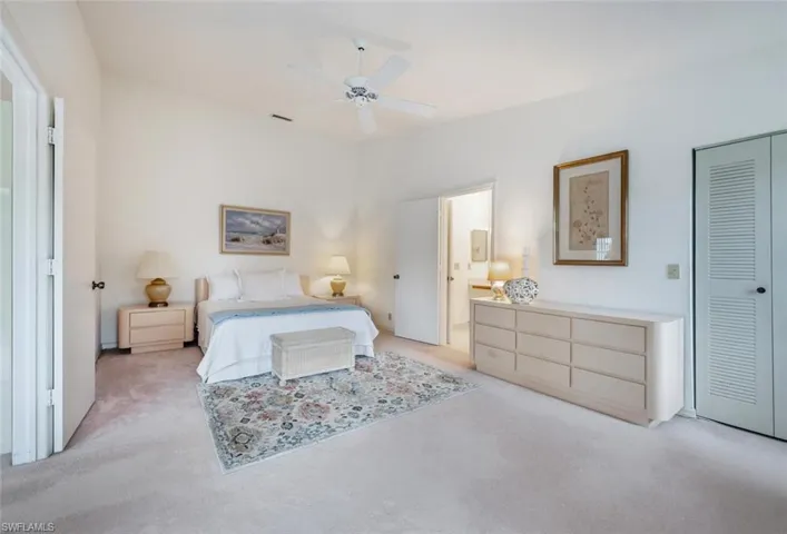 Carpeted bedroom featuring ceiling fan