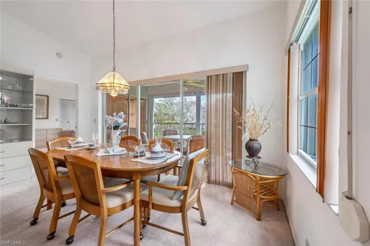 Dining area with carpet floors and a chandelier