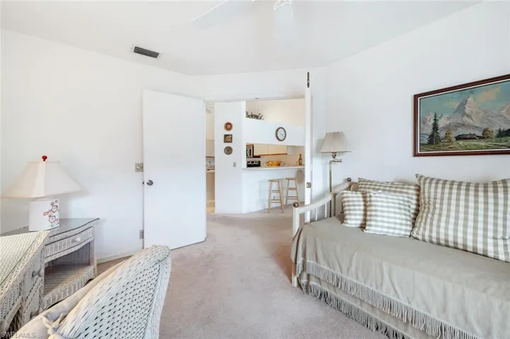 Carpeted bedroom featuring ceiling fan