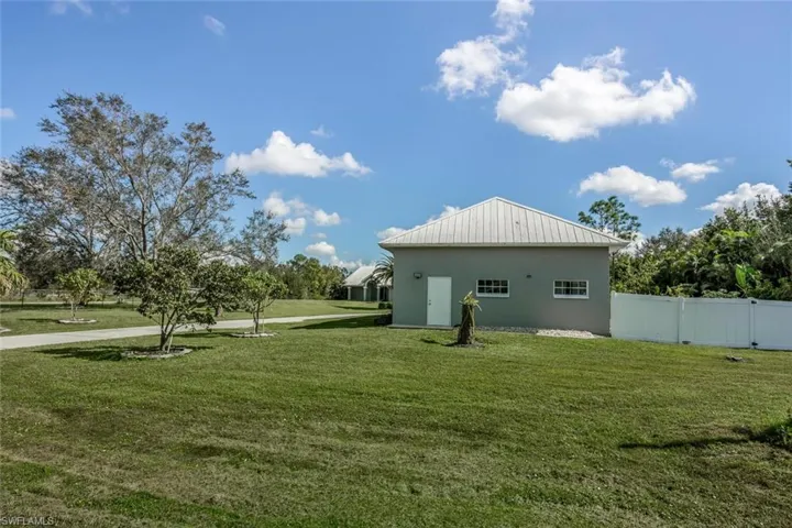 View of property exterior featuring a lawn