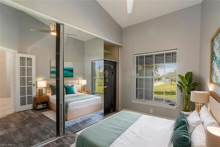 Bedroom featuring high vaulted ceiling, ceiling fan, and dark wood-type flooring