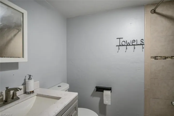 Bathroom featuring vanity, toilet, and walk in shower