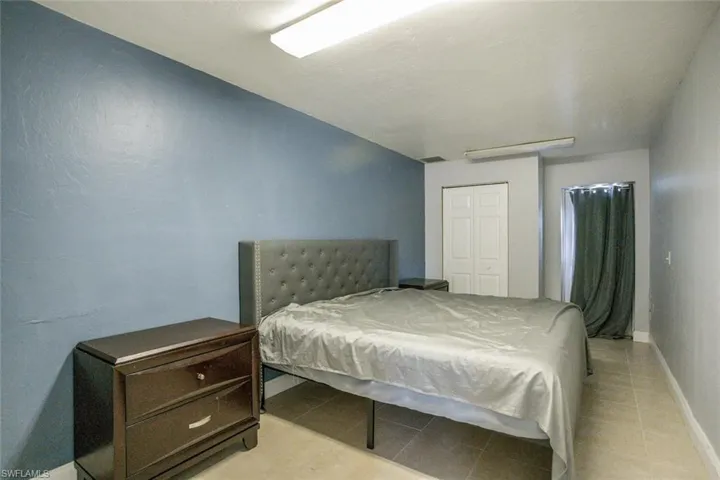 Bedroom featuring a closet and light tile patterned flooring