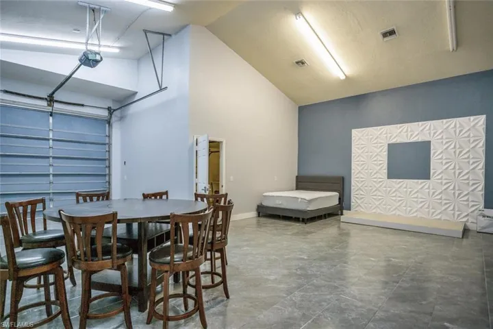 Dining area featuring high vaulted ceiling