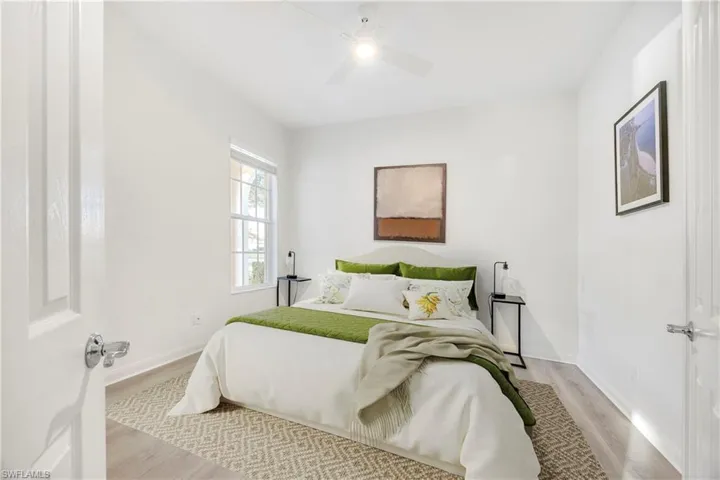 Bedroom with light wood finished floors and ceiling fan