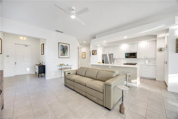 Living area featuring recessed lighting, light tile patterned floors, and ceiling fan