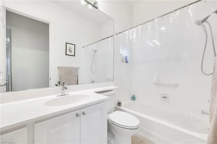 Bathroom with vanity and shower / bath combo with shower curtain
