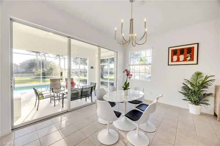 Dining area with a chandelier and light tile patterned flooring