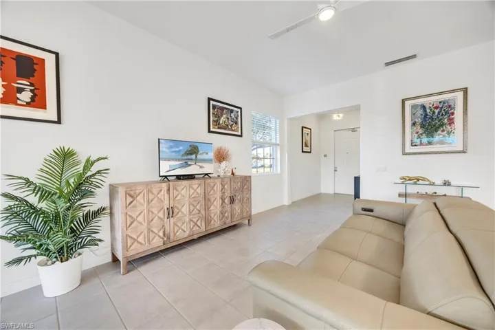 Tiled living room featuring ceiling fan