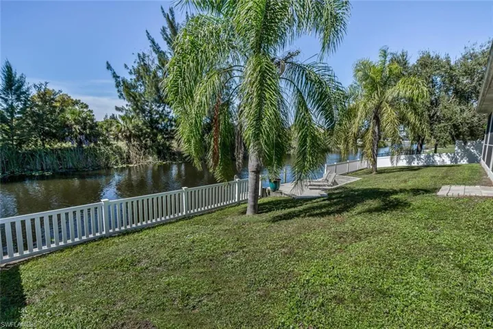 View of yard featuring a water view and a fenced backyard