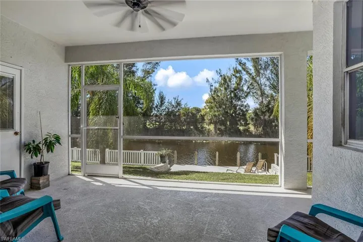 Sunroom / solarium featuring a water view and a ceiling fan