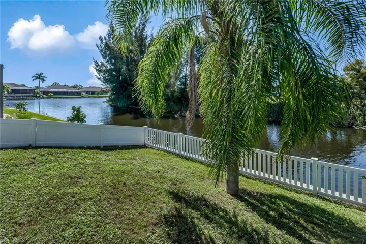 View of yard with a water view and a fenced backyard