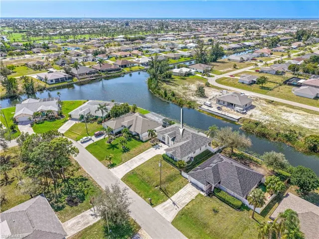 Aerial view with a water view and a residential view