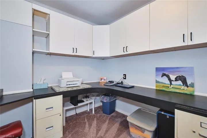 Office space featuring built in study area, carpet, and baseboards