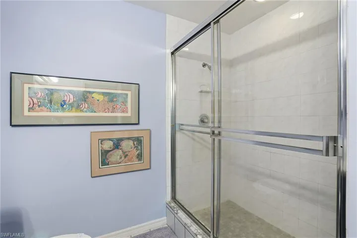 Full bathroom with a shower stall and toilet - Virtually Edited Image