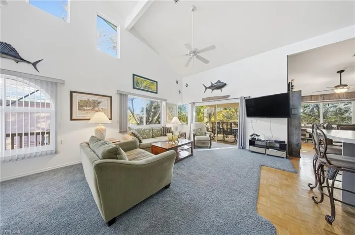 Living room with high vaulted ceiling and ceiling fan