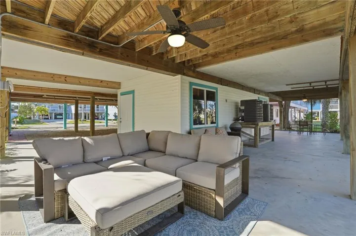View of patio with ceiling fan, outdoor dining space, and an outdoor living space - Virtually Edited Image