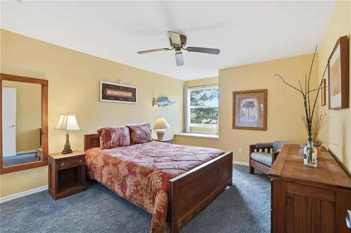 Bedroom with dark carpet and ceiling fan - Virtually Edited Image