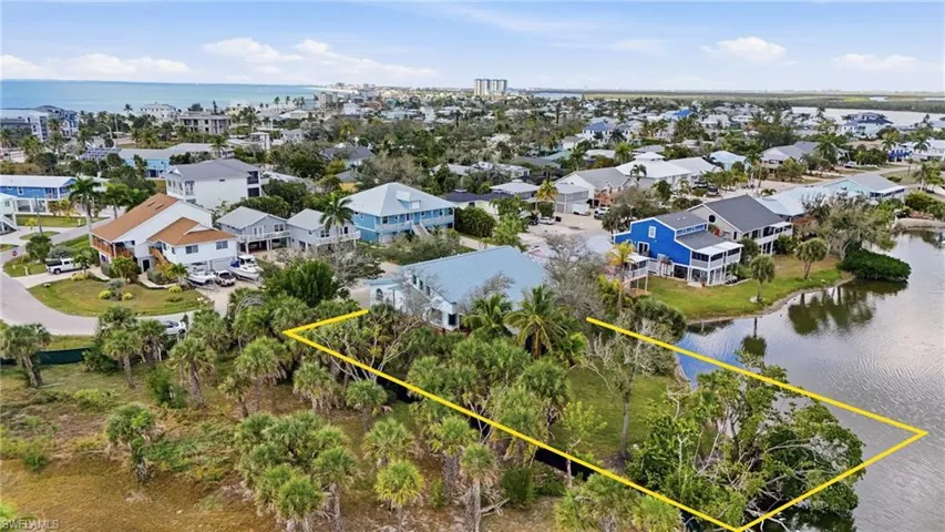 Aerial view of residential area featuring a large body of water - Virtually Edited Image