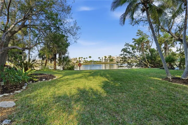 View of grassy yard featuring a water view - Virtually Edited Image