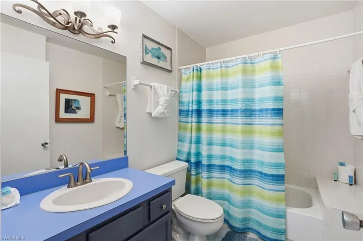 Full bath featuring vanity and shower / bath combination with curtain - Virtually Edited Image