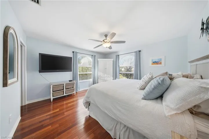 Bedroom with hardwood / wood-style flooring and ceiling fan
