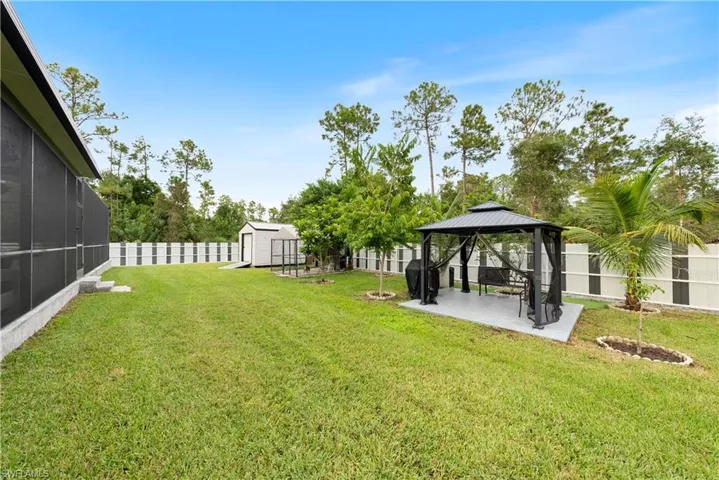 View of yard featuring a patio, a shed, and a gazebo