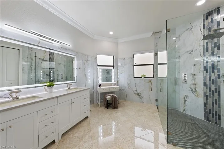 Bathroom featuring walk in shower, crown molding, a textured ceiling, and vanity