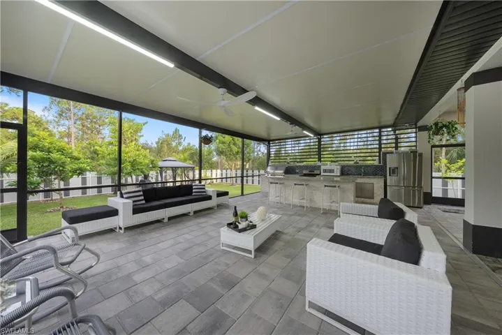 Sunroom featuring ceiling fan and a healthy amount of sunlight
