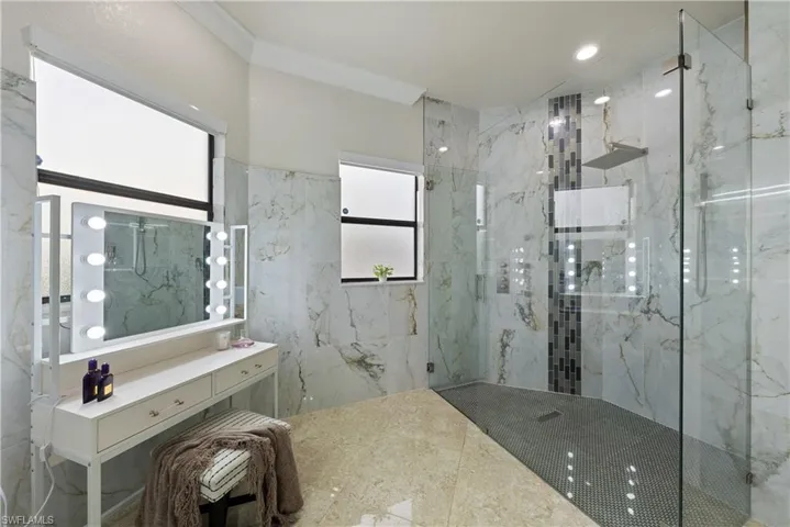 Bathroom featuring a wealth of natural light and an enclosed shower