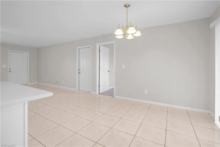 Spacious interior featuring tile flooring, light gray wall tones, and white trim