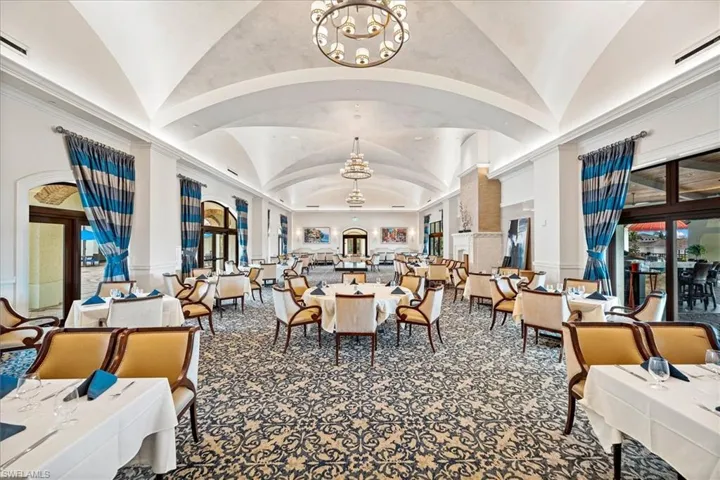 Main clubhouse dining area with high vaulted ceiling and an inviting chandelier