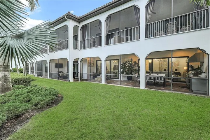 Rear view of property featuring a lawn