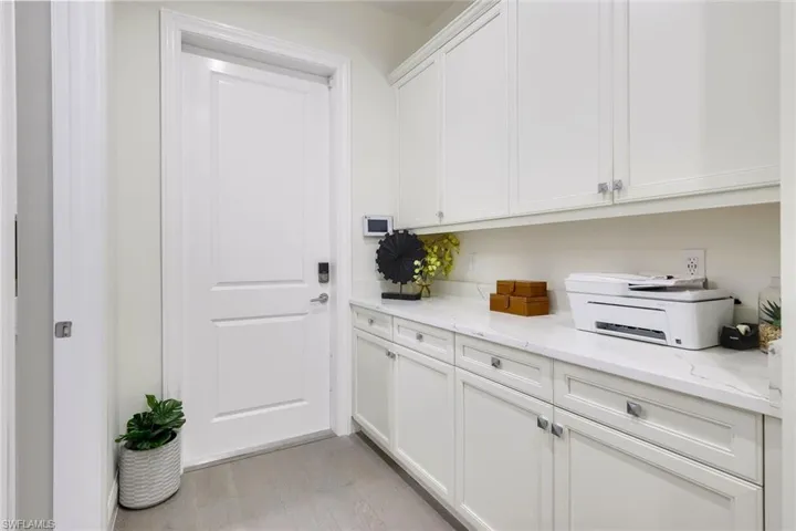 Built-in cabinets just inside the garage door entrance offering additional storage