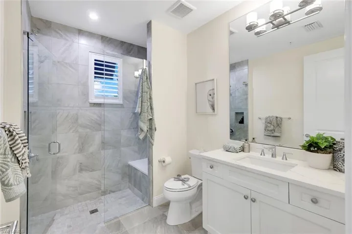 Bathroom ensuite with tile floors, quartz vanity and shower