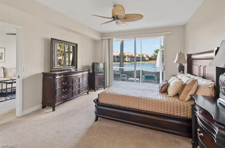 Bedroom with light carpet, access to exterior, and ceiling fan